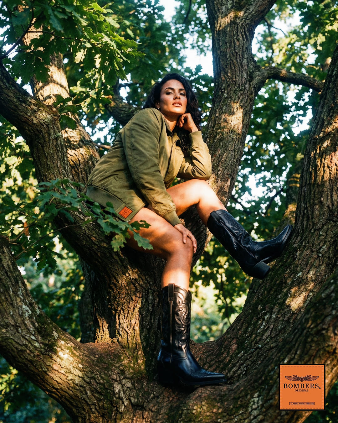 Bombers · fashion campaign, woman in bomber jacket and cowboy boots in oak tree